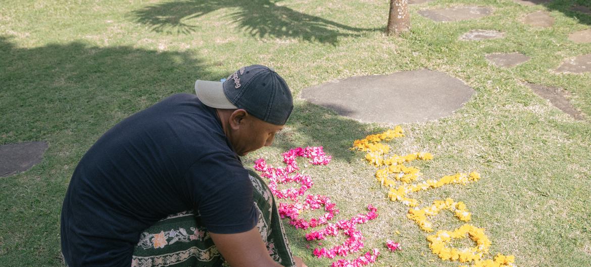 Dekha Dewandana arrange words with flowers at Esa di Kubu Homestay in Sudaji Village, Buleleng, Bali, Indonesia.